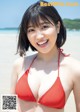 A woman in a red bikini on the beach.