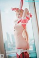 A woman in a bunny costume posing for a picture.